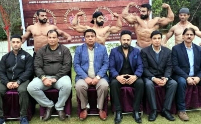 Dignitaries posing with bodybuilders at Jammu.