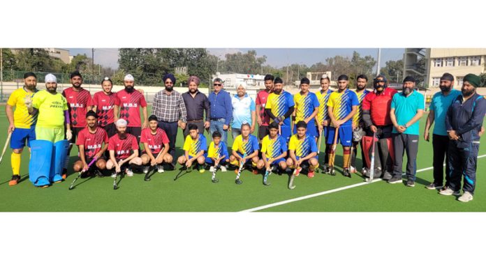 Hockey teams posing with dignitaries at KK Hakku Stadium Jammu.