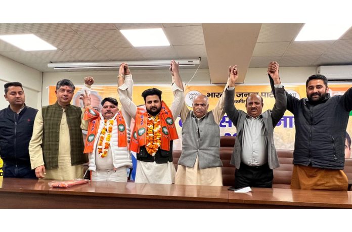 BJP leaders taking NSUI national coordinator and Apni Party leader into party fold with their supporters at Jammu on Monday.