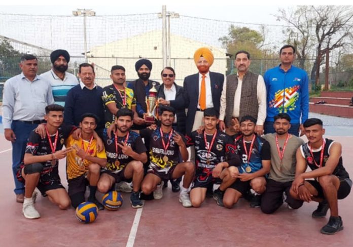Manmeet Singh Amn President and H.S Gill Secretary Jammu District Volleyball Association posing along with winning team at Jammu on Sunday.
