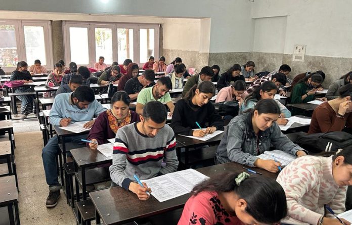 Students busy in taking their exam during a Mega Scholarship Test conducted by SRCC in Jammu on Sunday.