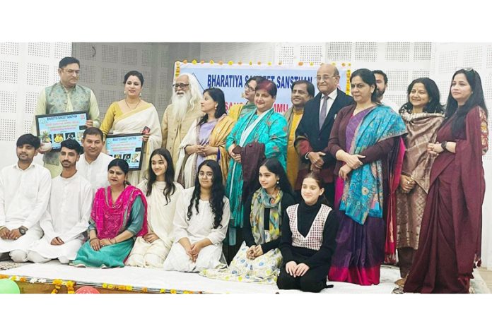 Guests posing with artists after a concert at KL Sehgal Hall, Jammu.