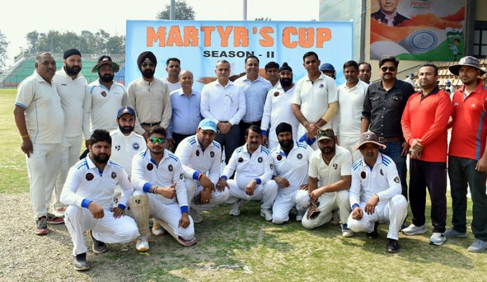 Players posing with dignitaries during an inaugural match of a cricket tournament at Jammu.