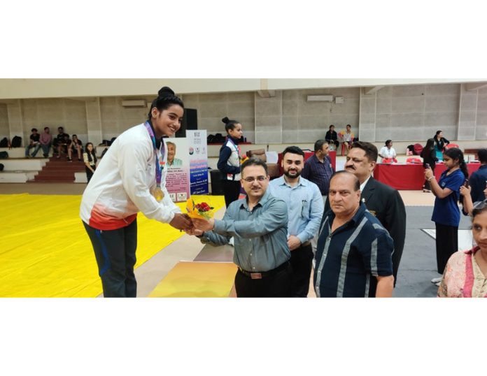 Kapil Sharma, MD J&K Medical Supplies Corporation Jammu presenting medal to a champion gymnast. -Excelsior/Rakesh