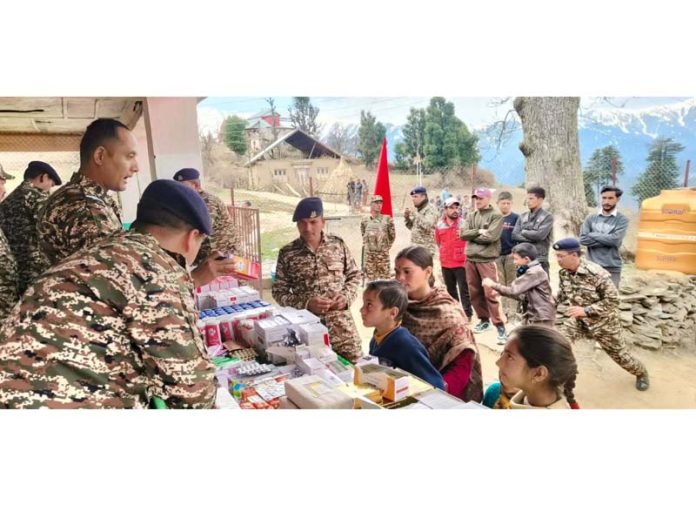 CRPF medicos giving medicines to people of Kansar village in Bhaderwah during a medical camp. -Excelsior/Tilak Raj