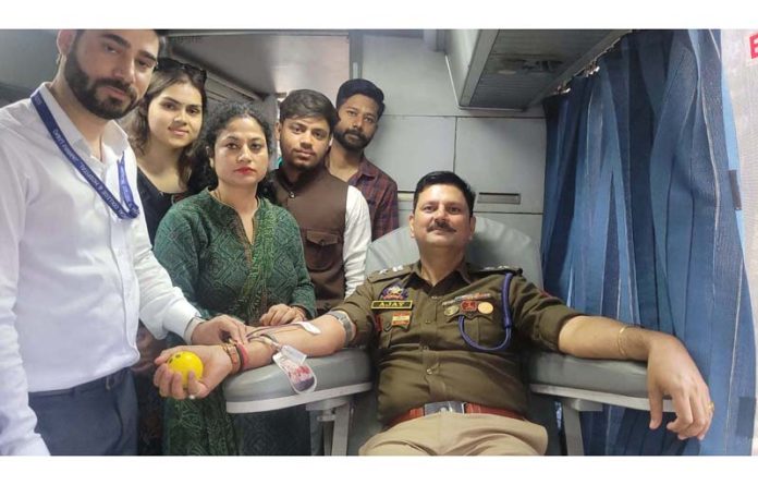 SP South Ajay Sharma donating blood during a camp organised by ABVP at University of Jammu on Friday.