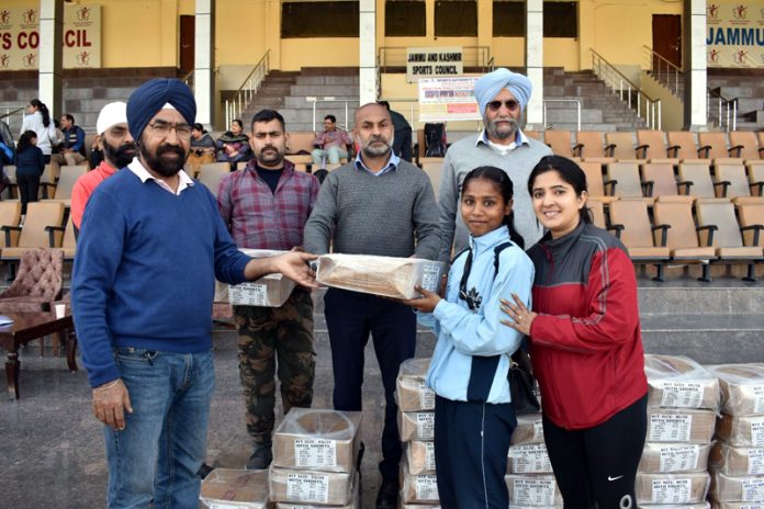  Divisional Sports Officer Jammu Baljinder Pal Singh presenting sports kits among trainees of Khelo India Centers.