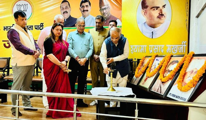 BJP leaders lighting the lamp during a party programme at Jammu on Tuesday.