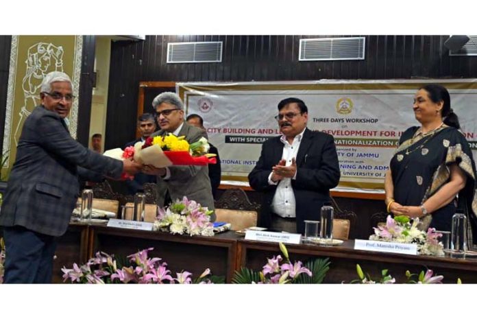 JU Vice-Chancellor presenting bouquet to Chief Secretary Atal Dulloo during valedictory function of workshop on Thursday.
