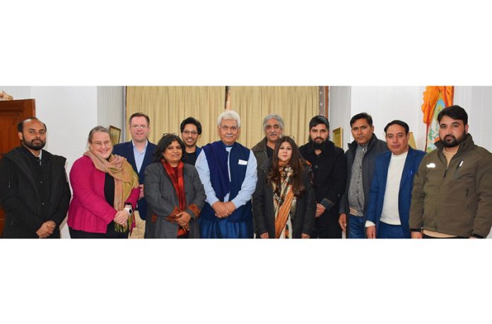 LG Manoj Sinha posing for a group photograph with delegation of intellectuals.
