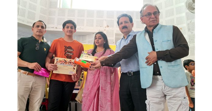 The chief guest giving certificates to the participants of Dogri 'Baal Kavi Goshthi' in Jammu on Sunday.