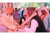 Senior BJP leader Devender Singh Rana seeking blessings during a congregation.
