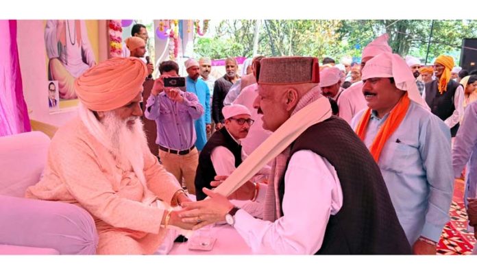 Senior BJP leader Devender Singh Rana seeking blessings during a congregation.