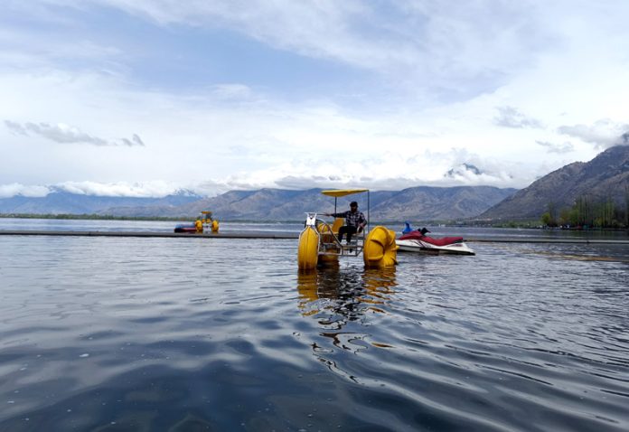 Man rowing newly introduced Aqua Cycle, which is becoming a new attraction for people on Dal Lake. -Excelsior/Shakeel