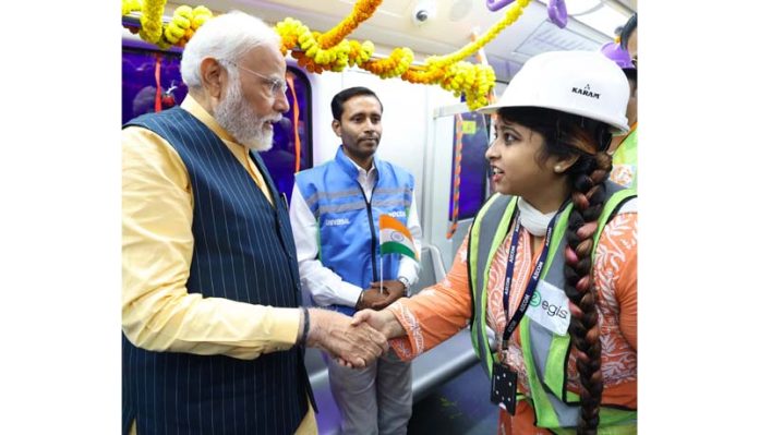 Prime Minister Narendra Modi interacting with the metro staff & school students as he travels with them in India's first underwater metro train during the inauguration and laying the foundation stone of multiple connectivity projects at Esplanade Metro Rail Station in Kolkata, West Bengal on Wednesday. (UNI)