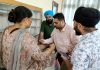 A doctor examining a patient during a medical camp at Jammu on Tuesday.