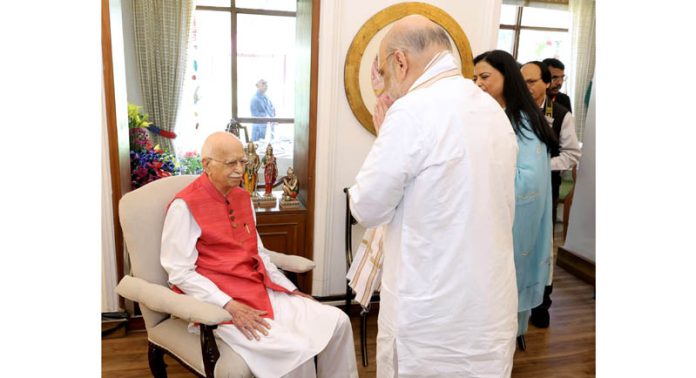Union Home Minister Amit Shah greets veteran BJP leader L K Advani before the latter was honoured with the 'Bharat Ratna' at his residence in New Delhi.