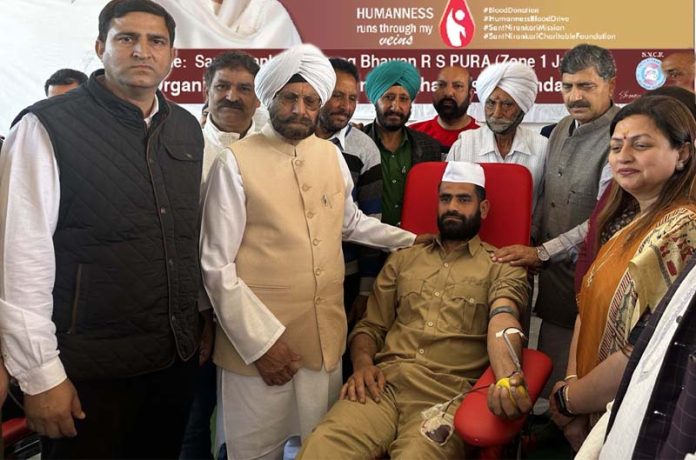 A volunteer donating blood during a camp at R.S Pura on Sunday.