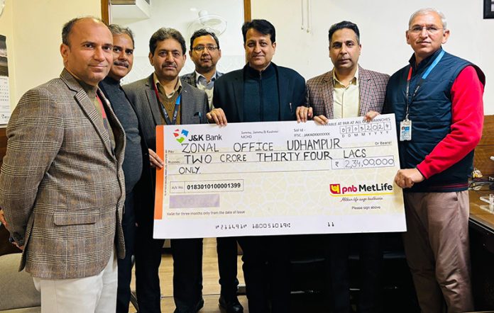 J&K Bank's Zonal Head (Udhampur) Rajesh Gupta handing over symbolic cheque to the nominees/legal heirs of the deceased customers on Monday.