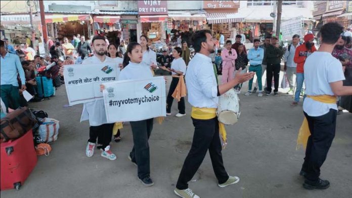 Artists of Sangam Theatre Group staging street play for election awareness.