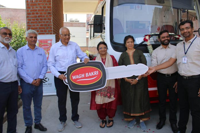 Raseshbhai Desai, MD, Wagh Bakri Tea Group donating a blood collection van to Muni Seva Ashram on Thursday.