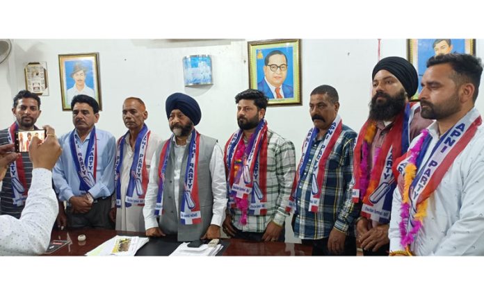 Apni Party leader, Manjit Singh and others posing for a group photograph at a meeting in Vijaypur.