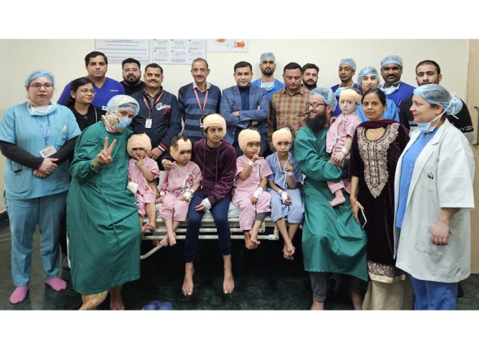 A team of doctors and other officials of SMVD Narayana Hospital Katra posing with children who underwent cochlear implant surgeries.