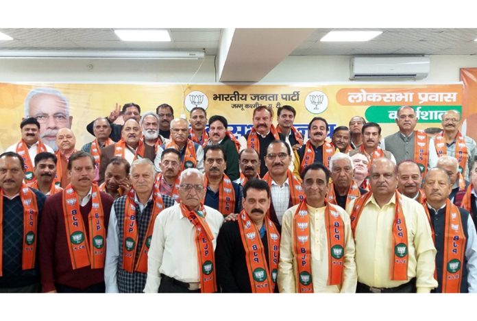 Senior ranking retired officials who joined BJP posing with party leaders at Jammu on Thursday.