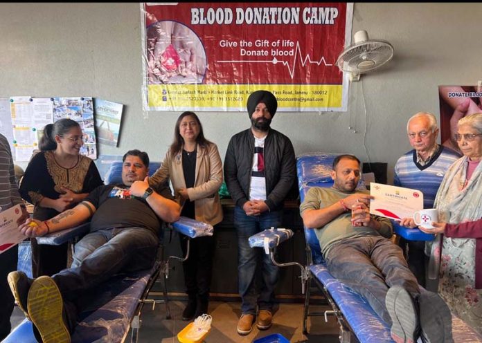 Volunteers donating blood during a camp in Jammu on Sunday.