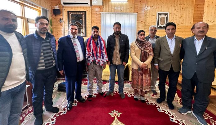 Apni Party president, Altaf Bukhari with new entrants posing for group photograph in Srinagar.