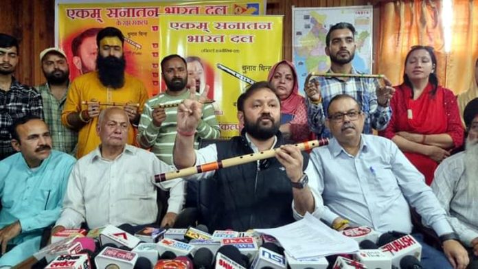 Ankur Sharma showing his party's common symbol, a flute, to media persons in Jammu on Tuesday.