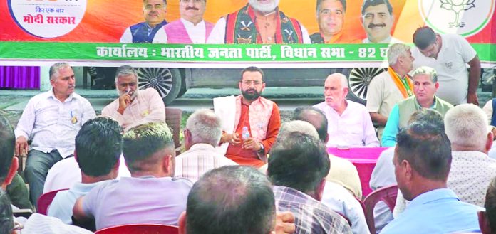 Narinder Singh Bhau along with Shamsher Singh Manhas addressing during a party workers meeting in Chhamb constituency on Wednesday.