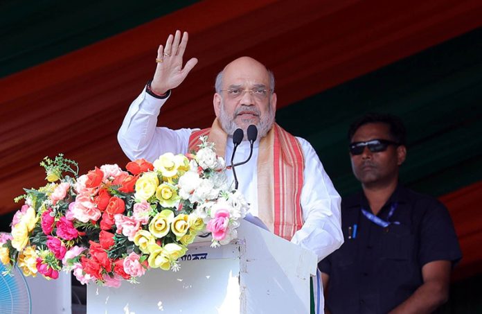 Union Home Minister Amit Shah addressing an election rally at Lakshimpur in Assam on Tuesday. (UNI)