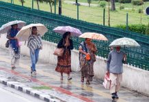 Tourist women walk with umbrellas in Srinagar on Thursday. -Excelsior/Shakeel