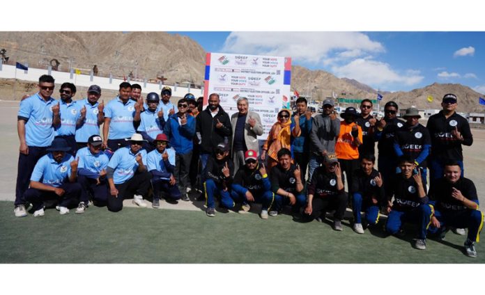 Dignitaries along with players posing during a cricket match organised by District SVEEP team, Leh on Tuesday.