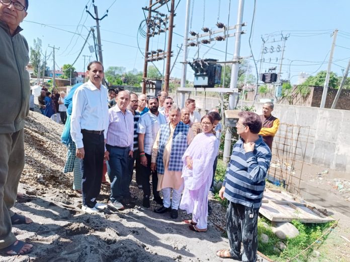 Former Minister Sat Sharma along with the residents of Durga Nagar, Ward No 40 in Jammu on Monday.