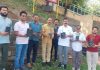 ADC Udhampur and others carrying rose saplings for plantation along Devika in Udhampur.