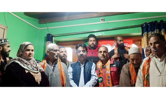 BJP leaders taking new entrants in party fold at Eidgah, Srinagar on Monday.