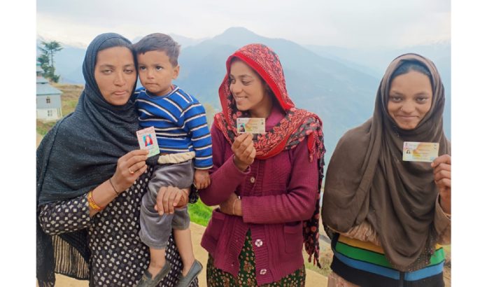 Three deaf and dumb sisters of village Dhadkahi show voters card before going to polling station in Doda on Friday.