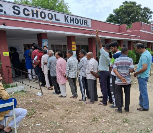 People line up for voting at a Polling Station in border village of Khour in Akhnoor sector.