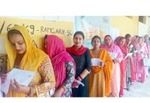 Women voters in a long queue in front of a Polling Station in border village of Bainglar in Ramgarh sector of Samba district on Friday. —Excelsior/Sambyal