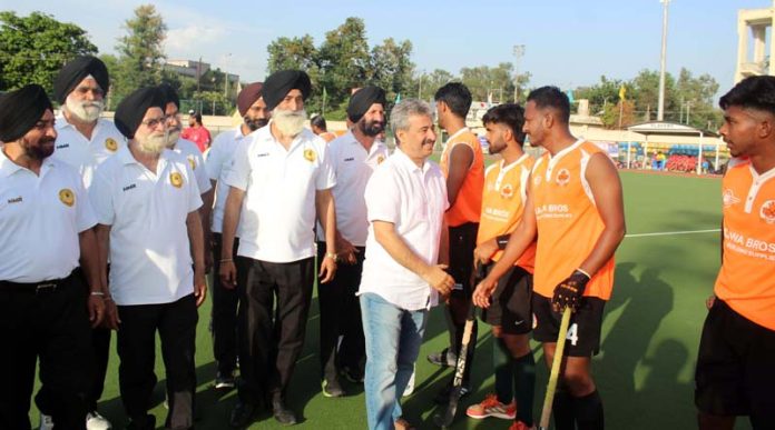 Chief guest interacting with players before start of 2nd semi-final match of Invitational Hockey Tournament at Jammu on Saturday.