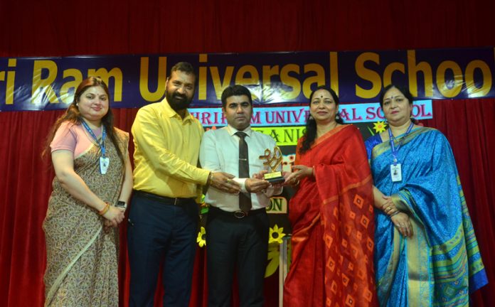  School management presenting memento to the chief guest during a programme on Sunday.