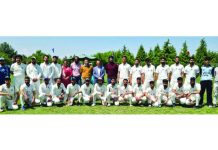Cricket teams posing alongwith Kashmir University faculty during an inaugural cricket match in Srinagar.  