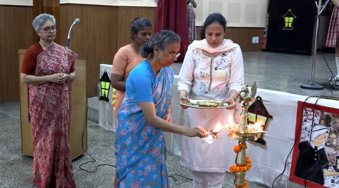 Faculty members lighting lamp during a programme in school on Thursday.
