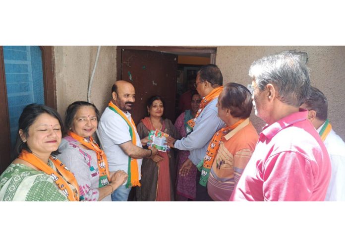 BJP senior leader and former Minister, Bali Bhagat during a door to door campaign in Jammu East Assembly Segment on Sunday .