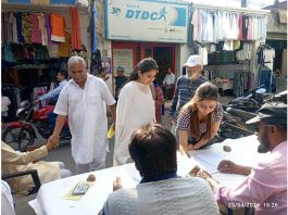 A lady putting her signature during a campaign organised by DADAA in Pacca Danga, Jammu on Tuesday.