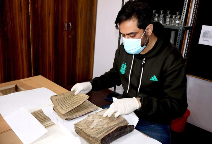 INTACH Conservator busy with restoration of historic Quranic manuscripts. —Excelsior/Shakeel