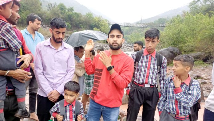 Villagers highlighting the difficulties being faced by them due to damaged wooden bridge. --Excelsior/K Kumar