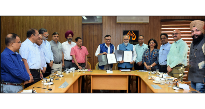 Vice-Chancellor of SMVDU and Director PEC displaying copies of MoU between the two institutes.